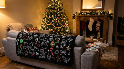 Christmas coloring blanket draped over the couch by the Christmas tree